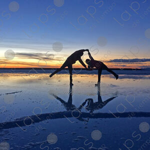 Adult and Child Holding Hands at Sunrise in Uyuni Salar