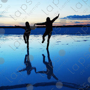 Adult and Child Holding Hands at Sunrise in Uyuni Salar
