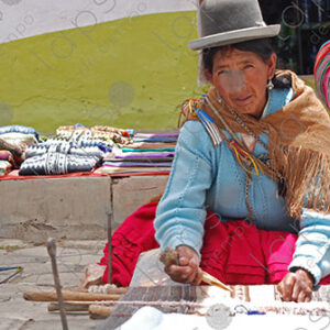 Bolivian lady weaving on her loom