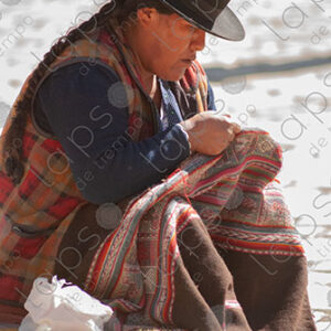 Bolivian woman arranging an awayo