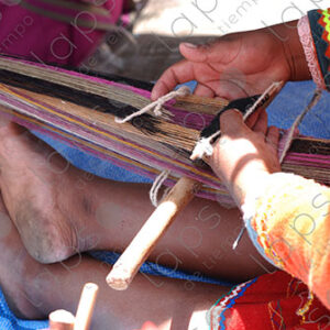 Detail of hands and feet, weaving on a loom