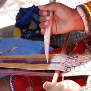 Detail of hands with bones, weaving on a loom