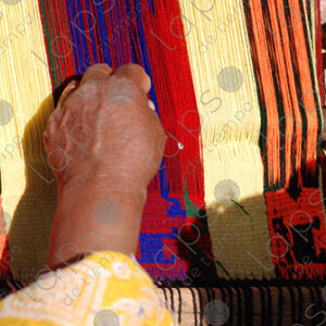 Detail of hands working on a loom
