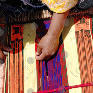 Detail of hands working on a loom
