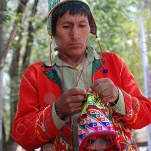 Man weaving colorful traditional hat