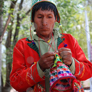 Man weaving colorful traditional hat
