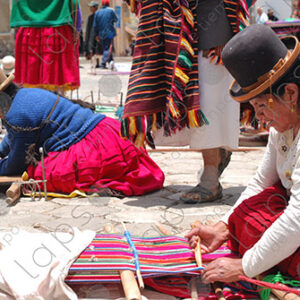 Several weavers on the floor with their looms