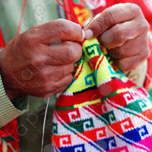 Detail of a mans hands knitting a hat