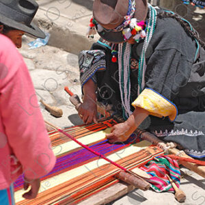 Indigenous woman working on loom