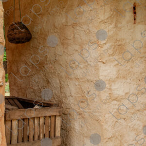 Adobe wall with rustic wooden structure