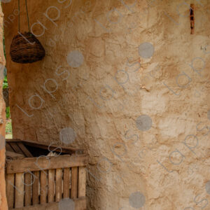 Adobe wall with rustic wooden structure