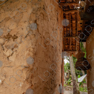 Adobe wall with rustic wooden structure