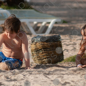 Boy and girl playing with sand