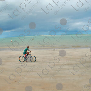 Boy riding a bicycle in the sand