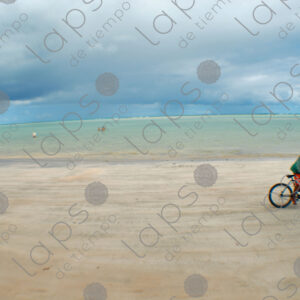 Boy riding a bicycle in the sand