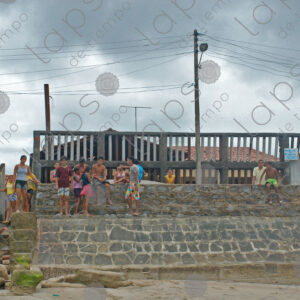 Group of children sitting on the wall