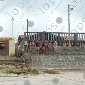 Group of children sitting on the wall