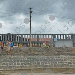 Group of children sitting on the wall