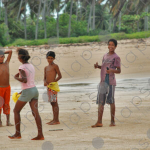 Group of teenagers standing on sand