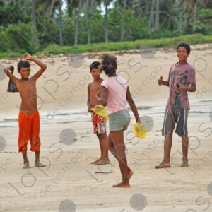 Group of teenagers standing on sand