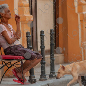 Lady smoking while seated on a chair