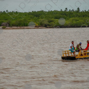 Landscape of a river with three men in a barge