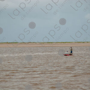 Landscape of a river with two men on a raft