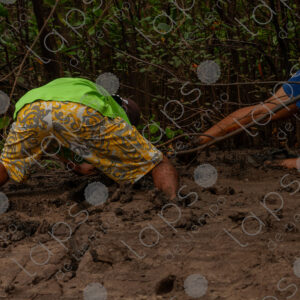 Man in the mud looking for crabs