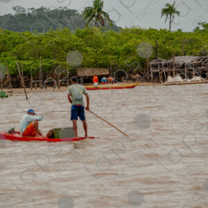 Men on a small raft in the middle of the river.