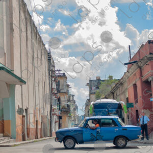 Old blue car passing