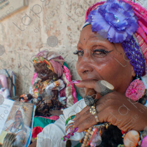 Portrait of a Cuban lady's face and nails with a cigar (habano)