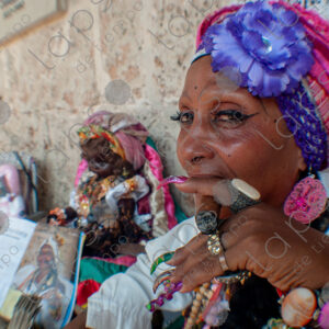 Portrait of a Cuban lady's face and nails with a cigar (habano)