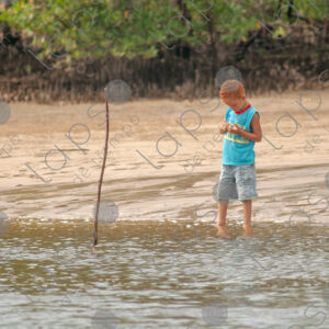 Redhaired boy by the riverside