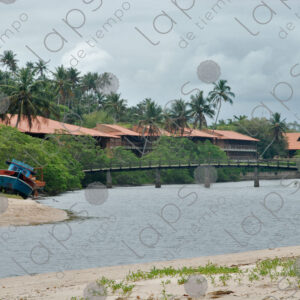 River landscape with bridge and hill with palm trees