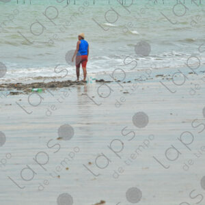 Sea shore child plays mother near