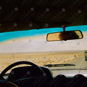 Desert Road View from Windshield with Woman Driver