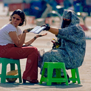 Islamic-Dressed Woman Adorning Hands with Henna, Marrakech