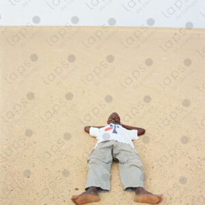 Man lying in the sand of the Western Sahara desert