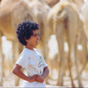 Nomadic Sahrawi girl with her camels