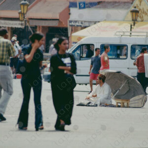 Two Women in Black Walking in the Atmosphere of Jemaa el-Fna Square, Marrakech