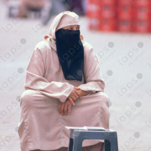 Woman in Islamic Attire Waiting Seated, Marrakech