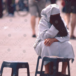 Woman in Islamic Attire Waiting Seated with Henna Art, Marrakech