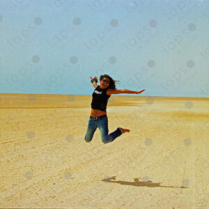 Woman jumping in the Western Sahara desert