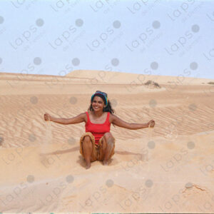 Woman plays with sand in the desert