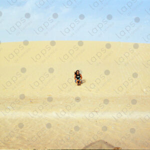 Woman sitting on a dune in Western Sahara