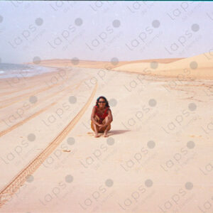 Woman sitting on beach on the Western Sahara coast