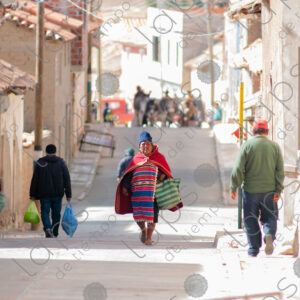 Woman in traditional attire walking on the streets of Tarabuco