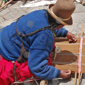Bolivian woman weaving on her loom