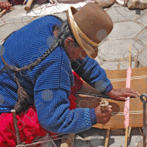 Bolivian woman weaving on her loom